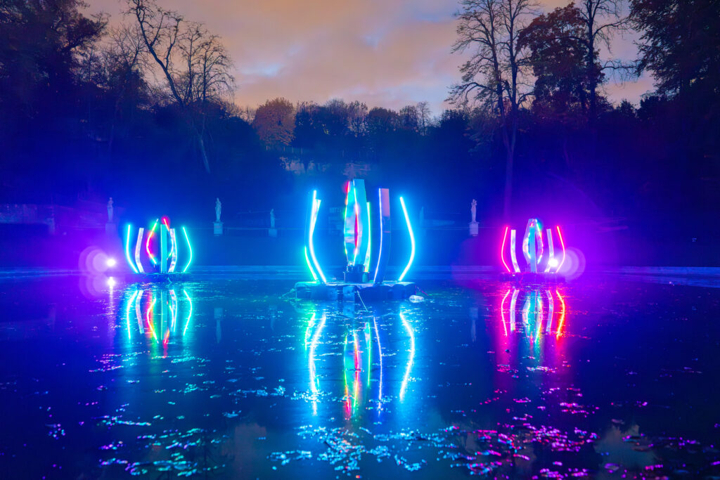 Colorful LED lights reflecting on water at night.