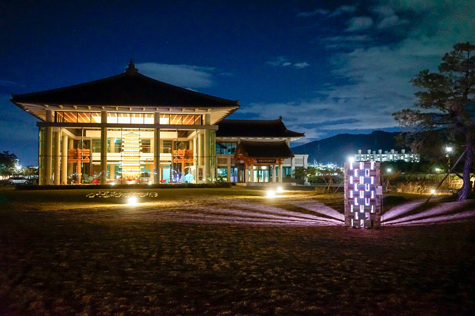 Illuminated building and sculpture at night scene